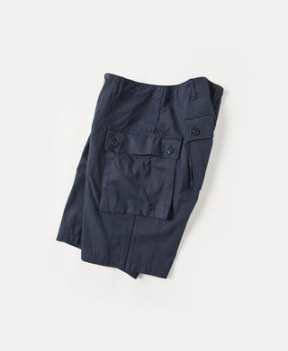 Navy utility shorts with side cargo pocket flaps and button closure
