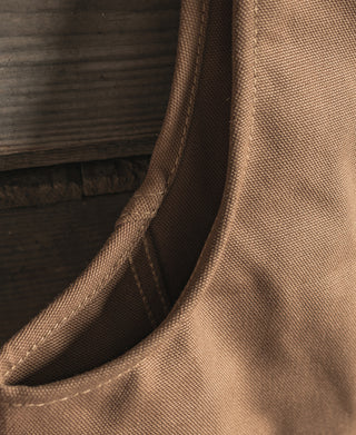 Close-up of khaki canvas hunting vest armhole curve and interior lining