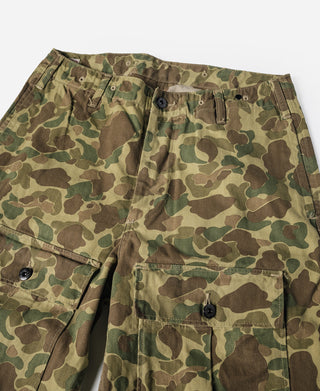 Camouflage cargo pants close-up with buttoned waistband and flap pockets