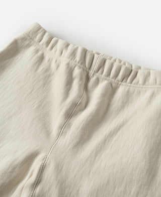 Light cream sweatpants waistband and side seam detail with soft fabric texture