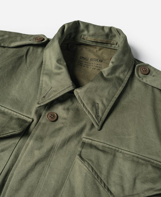 Olive field jacket collar with snap buttons and interior garment label