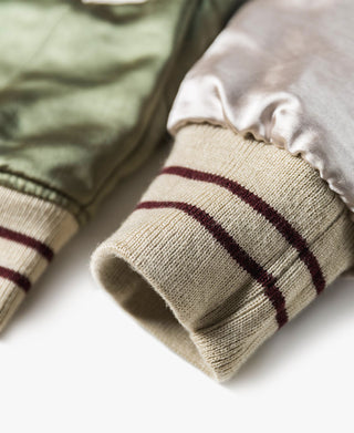 Reversible jacket cuff in cream rib knit with maroon stripes and pale satin lining.