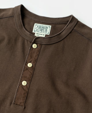 Coffee-brown henley shirt close-up: three-button placket and ribbed crew neck