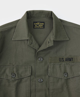 Olive fatigue utility shirt close-up of button front, collar, and flap chest pockets