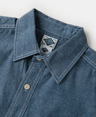 Blue chambray work shirt collar and button placket with brand label inside
