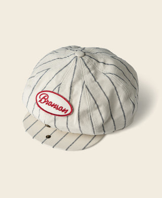 White pinstripe newsboy cap with Bronson logo patch and stitched button top