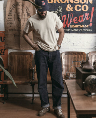 Apricot athletic T-shirt with crew neck and short sleeves, styled with jeans.