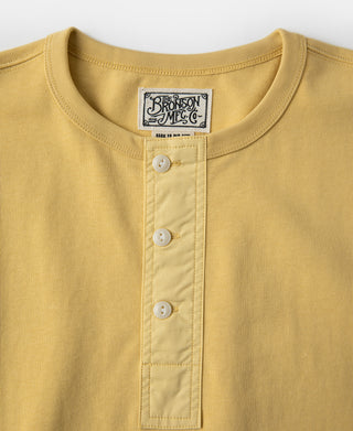 Yellow henley T-shirt neckline with label and three-button placket