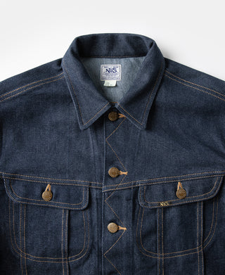 Indigo denim jacket close-up of shirt collar, snap buttons, and front flap pockets.