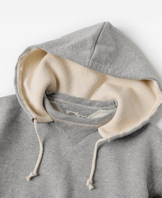 Gray hooded sweatshirt with cream knit hood lining and drawstrings