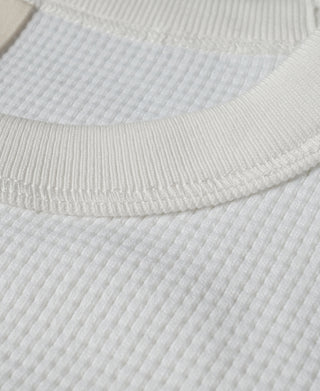 White waffle-knit cotton crew neckline and ribbed collar band close-up