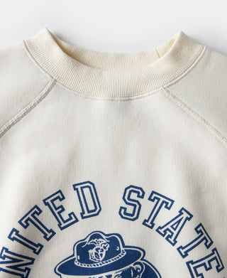White raglan sweatshirt neckline with blue chest logo graphic and ribbed collar