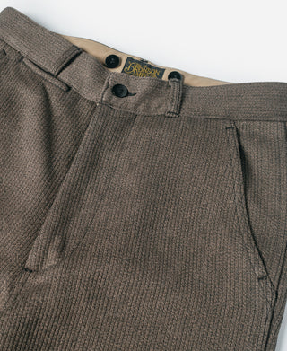 Brown salt-and-pepper stripe pants with button front, belt loops, and pleated waist