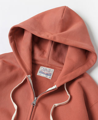Brick red terry cloth full-zip hoodie hood detail with white drawstrings and tag