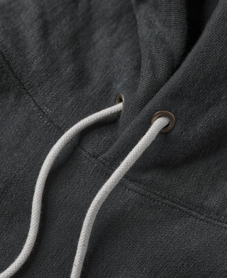 Hood drawcord with metal grommets on black pullover hoodie