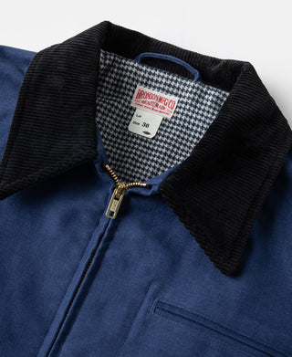 Black corduroy-style collar and houndstooth lining near front zipper on blue jacket