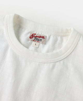 White T-shirt neckline with red brand label and size tag