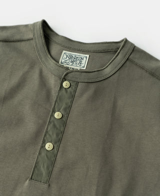 Light olive henley neckline with three-button placket and woven logo patch