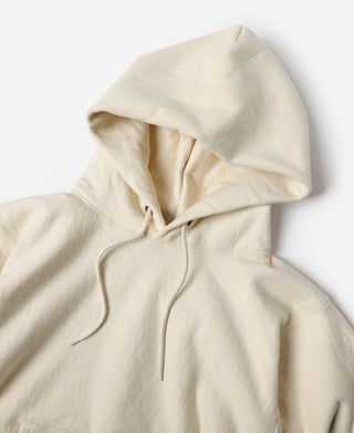 Apricot reverse-weave pullover hoodie front with drawstring hood and kangaroo pocket.