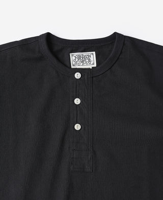 Black henley T-shirt neckline with round buttons and placket