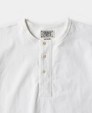 White henley t-shirt front with button placket and small brand label