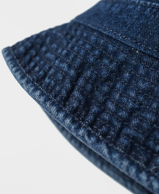 Indigo herringbone denim bucket hat, close-up of stitched brim pattern
