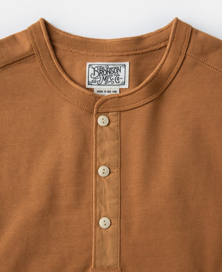 Vintage long-sleeve henley shirt close-up: dark orange three-button placket and collar