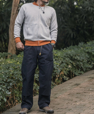 Navy cotton canvas climbing pants with elastic waistband and relaxed tapered fit