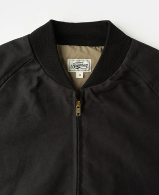 Black bomber jacket with ribbed collar and gold-tone zipper at center front