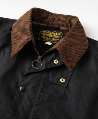 Black waxed jacket with brown corduroy collar, snap buttons and zipper pull