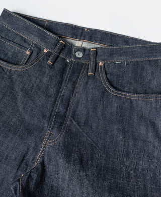 Indigo denim jeans front with button closure, coin pocket, and belt loops