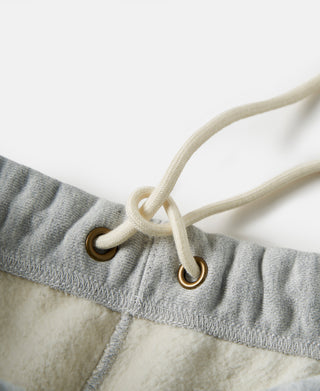 Light gray sweatpants waistband with drawstring and metal grommets