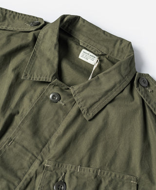 Olive fatigue jacket collar with button closure and woven neck label