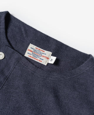 Navy henley neckline with button placket and size label