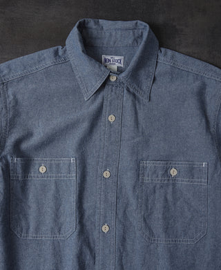 Blue chambray shirt front close-up with button placket and two chest pockets