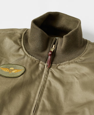 Olive zip-up bomber jacket neckline detail with knit rib collar and zipper seam.