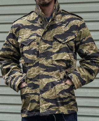Camo tiger-stripe M-65 field jacket with buttoned front and flap chest pockets