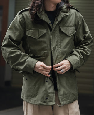 Olive field jacket with two flap chest pockets and button front
