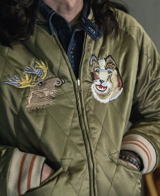Reversible souvenir jacket with quilted olive fabric and embroidered animal patches