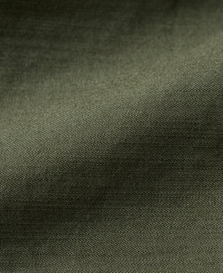 Olive woven jacket fabric close-up with fine mesh texture