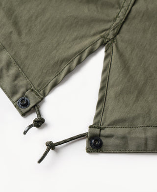 Olive M-65 parka hem drawstring with cord lock and snap-button cuff.
