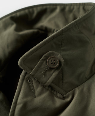 Olive flight jacket collar detail with snap button and stitched pocket flap