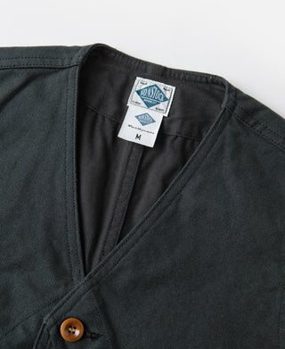 Dark green canvas vest neckline with V-stitch trim and wood-look button