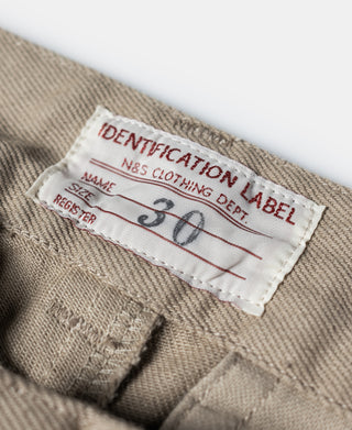 Khaki fabric care label inside waistband of chino pants