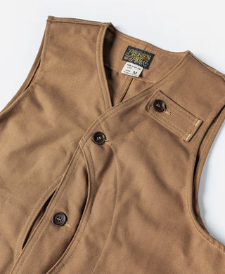 Close-up of khaki canvas hunting vest with button placket and chest pocket