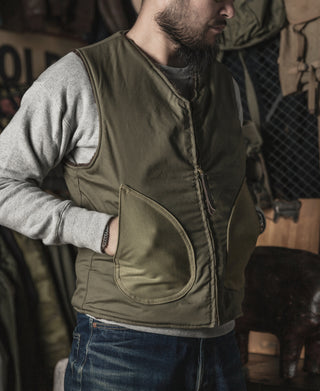Olive pile-lined vest with two side patch pockets and center zip
