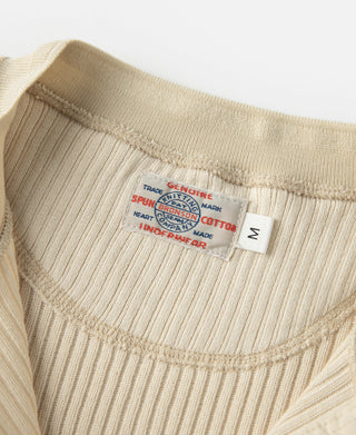 Ribbed henley T-shirt chest area with brand label tag, light apricot