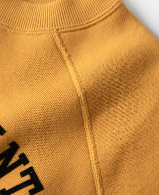 Yellow raglan sweatshirt side seam detail with ribbed knit panel