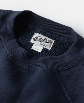 Navy raglan crewneck sweatshirt neckline with inner label tag