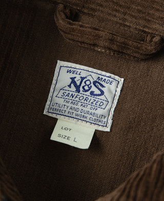Brown corduroy jacket care label patch and size tag at the inner neck.